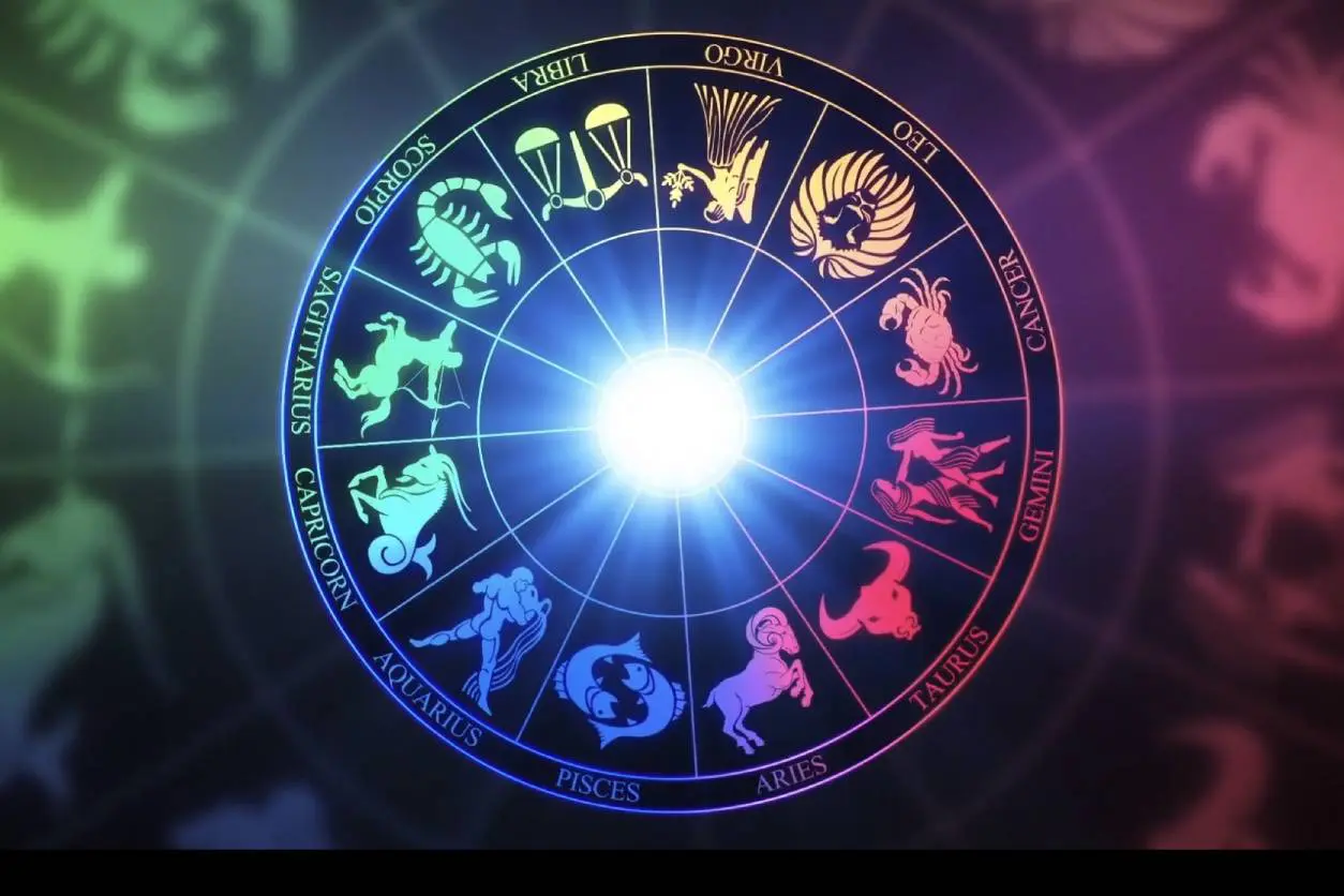 A circle of zodiac signs with the sun shining through.