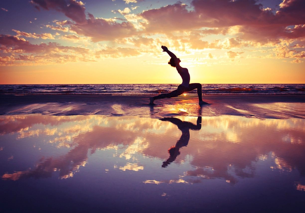 A person is doing yoga on the beach